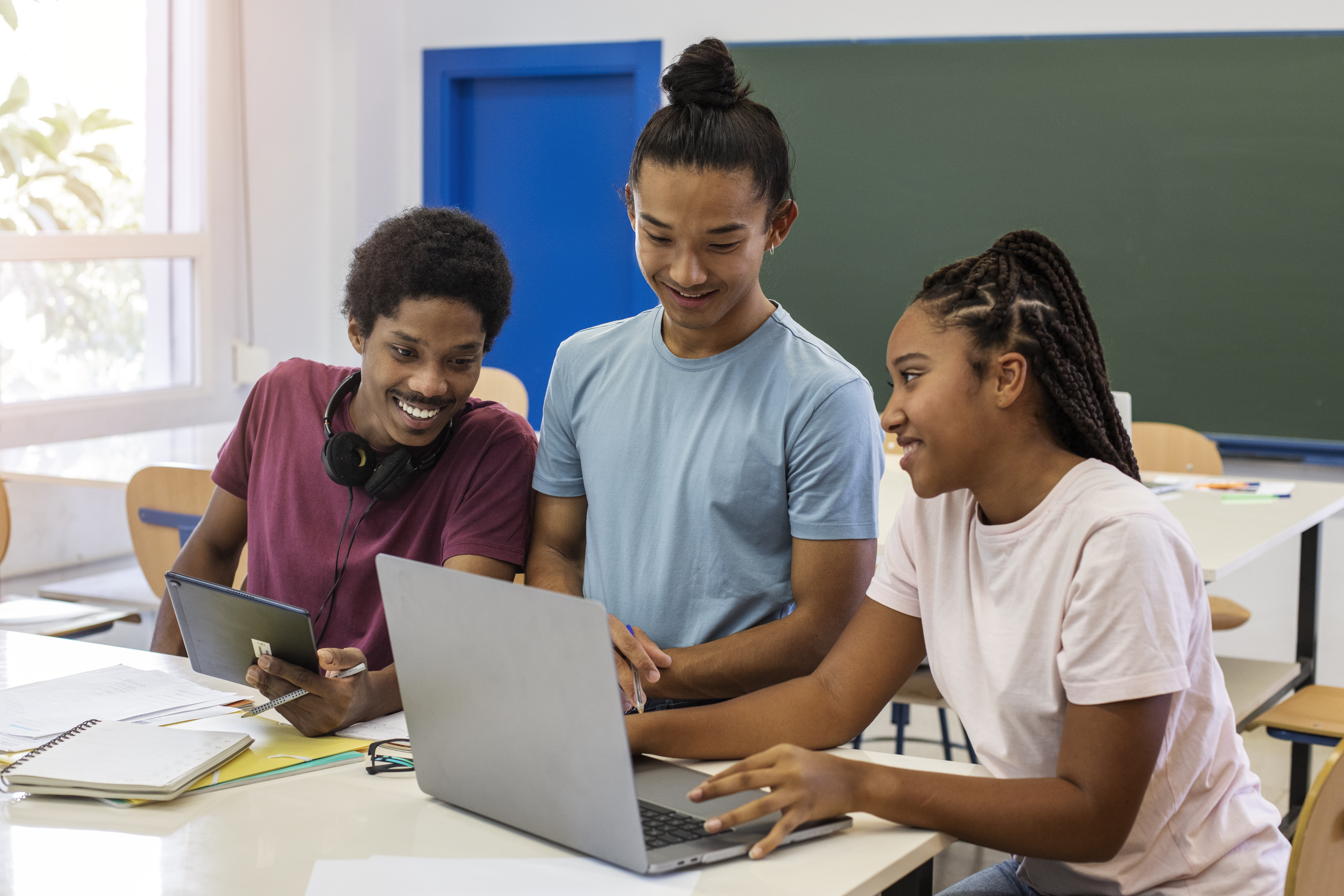 Students collaborating around a laptop